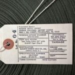 Tag of origin for upcycled military strap fabric used for our rental lanyards