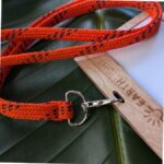Upcycled orange drawstring lanyard with plastic-free, reusable name tag holder for sustainable events