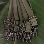 Close up of gunmetal hardware for adjustable salvaged material lanyard