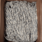 Box of scrap hoodie strings made into recycled lanyards for our rental program for sustainable events and conferences