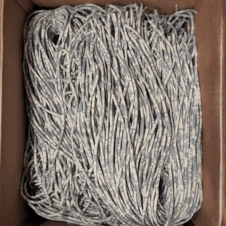 Box of scrap hoodie strings made into recycled lanyards for our rental program for sustainable events and conferences