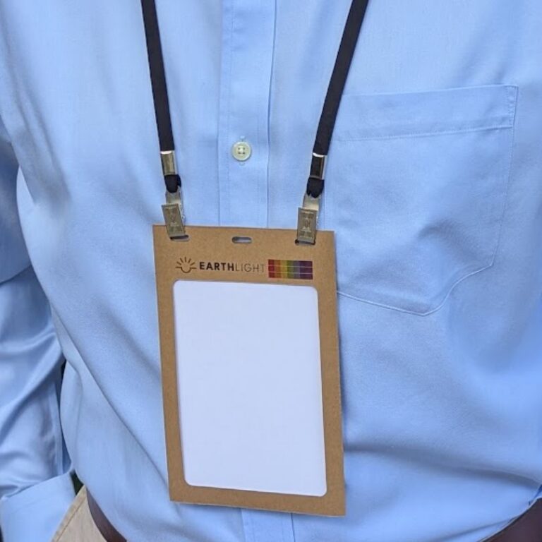 Person wearing kraft paper conference 4.25 X 6 badge holder and salvaged double bulldog hook lanyards made in USA