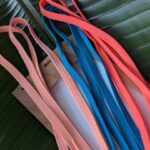 Colorful, plain, unbranded lanyards made from sustainable , salvaged scrap drawcords in blue and pinks