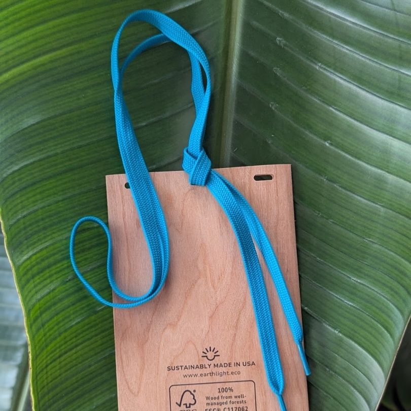 Back of plastic free, sustainable wood paper name badge with electric blue scrap string lanyard made in USA