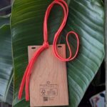 Back of plastic free wood badge holder with pink salvaged drawcord lanyard made in USA
