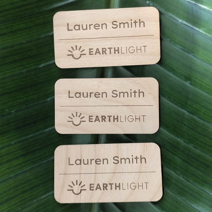 View of three eco-friendly, plastic free alderwood name tags personalized and made in USA