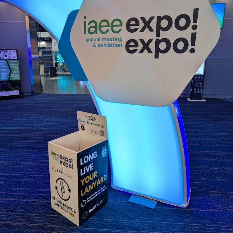 Expo signage with floor-standing lanyard return and collection boxes for rental and lanyard reuse and recycling program