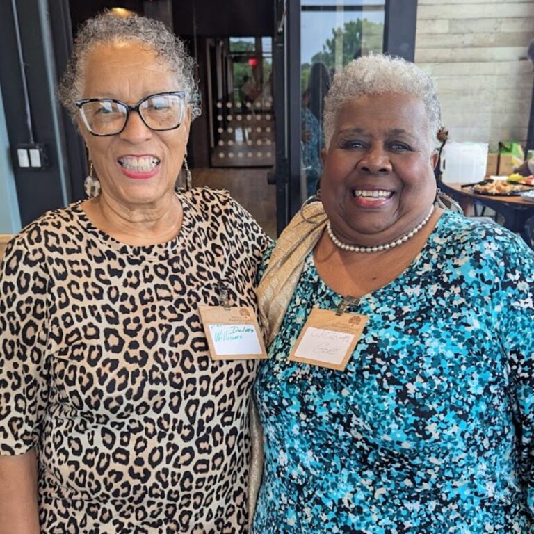 Two women wearing reusable, laser custom branded name tag holders for Hoosier Environmental Council with reusable metal double clips for sustainable event