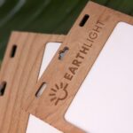 Close up of logo laser branding on a plastic-free Cherry wood name tag holder as a reusable, sustainable event and meeting solution