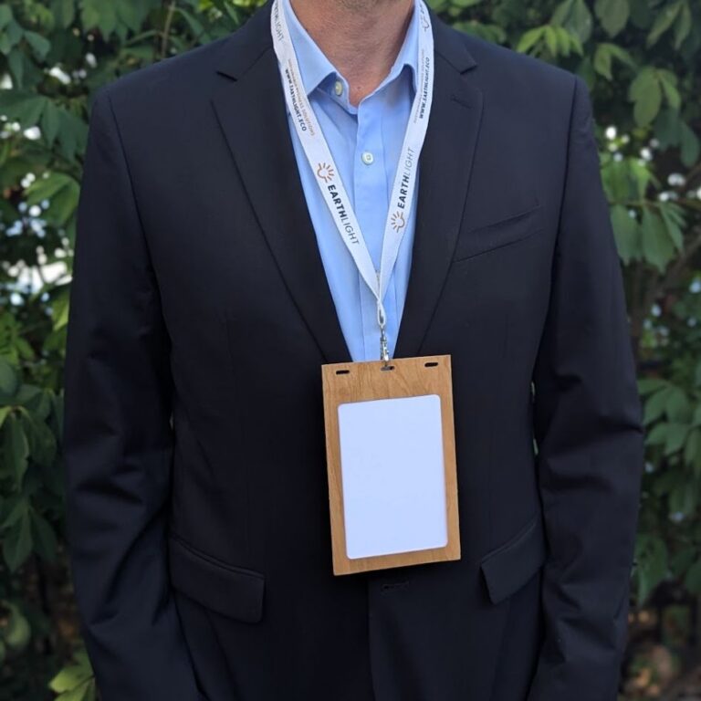 Person in suit jacket wearing plastic-free, wood Cherry badge holders for 4.25" x 6" inserts