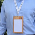 Close up of person wearing Cherry wood name badge holder with custom print branding