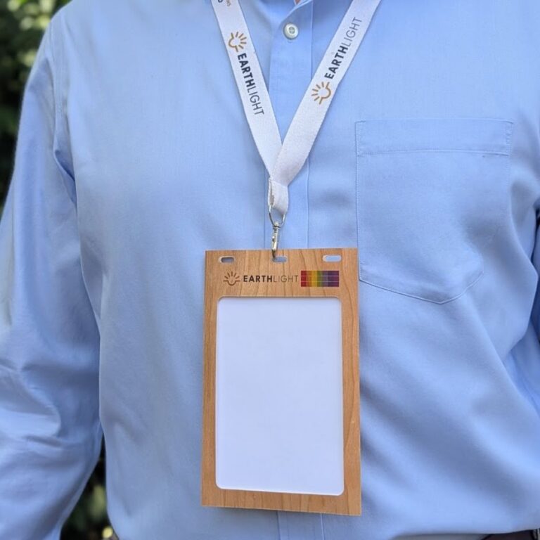 Close up of person wearing Cherry wood name badge holder with custom print branding