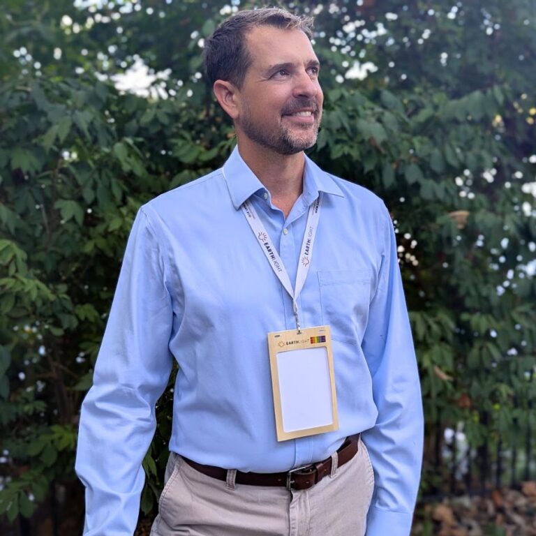 Person wearing plastic-free, wood overlay 4.25" x 6" name badge holder for sustainable event